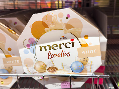 Villach, Austria - August 12, 2025: Merci Lovelies white chocolate gift box by Storck displayed on a store shelf, featuring colorful packaging and enticing design elements for festive occasions