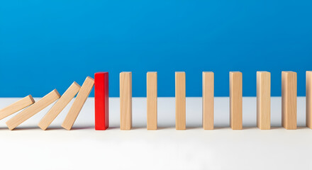 Focus on red object refusing to bend under harsh circumstances affecting other in irreversible sequence of domino effect. One special tile out of many is stopping falling. Strong individual concept