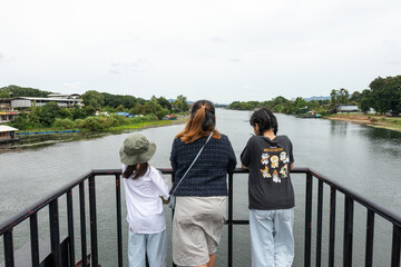 Fototapeta premium Family Touring Bridge Over River Kwai, Thailand
