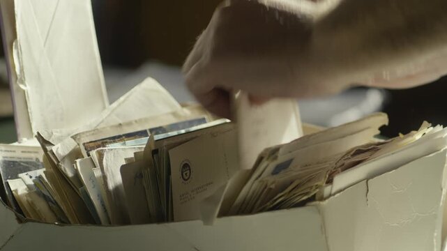 Hands searching old legal mail documents from personal archive folder CLOSE-UP