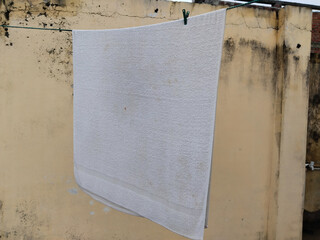 white towel drying in sunlight
