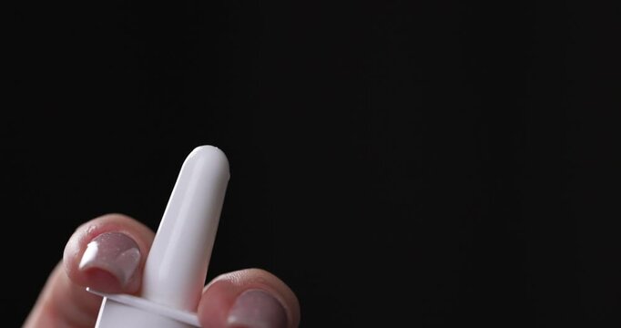 Closeup Person Holds in Hand Aerosol Bottle with Pharmaceutical Preparation, Spraying Medicine from Cold, Virus, Flu, Runny Nose. Medical and Healthcare Concept. Nasal Spray, Vasoconstrictor Addictive