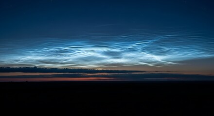 Noctilucent Clouds Illuminated by the Sun Below the Horizon Creating an Ethereal Blue Glow in the Twilight Sky