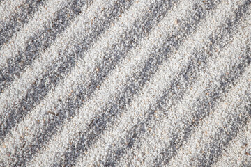 Sand patterns. Patterns formed on small white stone chips. Landscape design background.