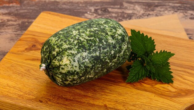 Yarg (England, Cornwall)
A semi-hard cow&rsquo;s milk cheese wrapped in nettle leaves, forming a mottled green and silver rind around a lemony, crumbly interior. 