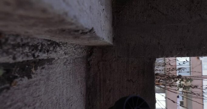 POV, blowing away garbage and leaves on the street with a turbo fan, vertical video