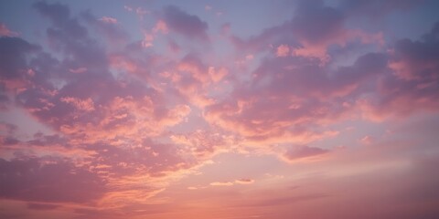 Obraz premium A beautiful sunset sky with soft pink and purple clouds.