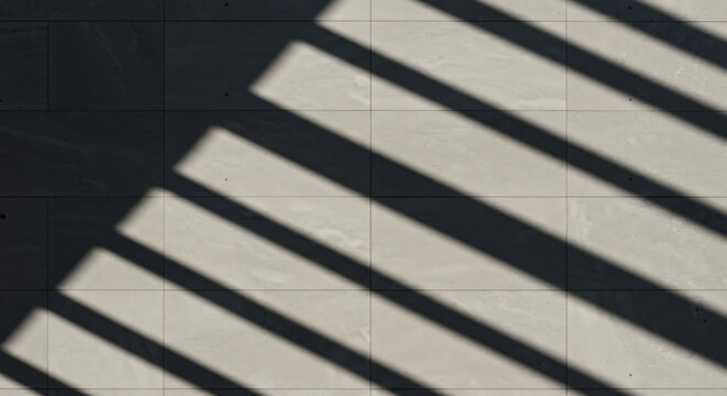 Shadows of parallel lines create an abstract geometric pattern on a wall