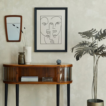 Stylish composition of creative living room interior with mock up poster frame, wooden commode, grey chair, palm, mirror, dry banch in vase and elegant personal accessories. Template.