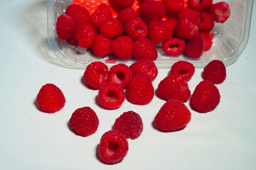 Fresh, ripe raspberries with vibrant red color, typical of summer harvest. Juicy and sweet berries, ideal for healthy food, natural desserts, and organic seasonal nutrition concepts.