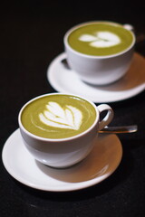 Hot Matcha Drink on wooden table background