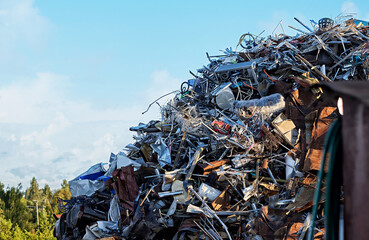 A large pile of scrap metal consisting of various materials: steel, aluminum, metallic components....