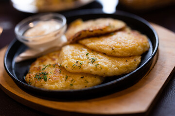 Potato pancakes with sour cream closeup. Belorussian cuisine