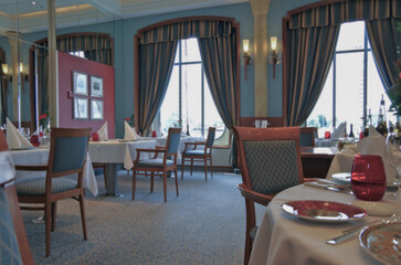 Formal and elegant ocean view dining room restaurant onboard luxury cruiseship or cruise ship liner...