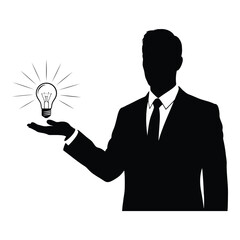 Silhouette of a businessman holding a glowing light bulb representing an idea