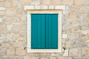 A window with green shutters. Croatian architecture on the island of Brac. Croatia