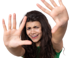 Portrait of a serious young woman showing stop gesture with her palm over white background