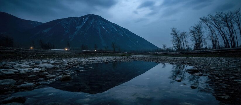 Mountain reflection in a tranquil pool of water at twilight