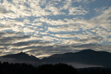 Morning fog with pink clouds, mountain landscape