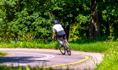 Naklejka premium Cyclist ride on the bike path in the city Park 