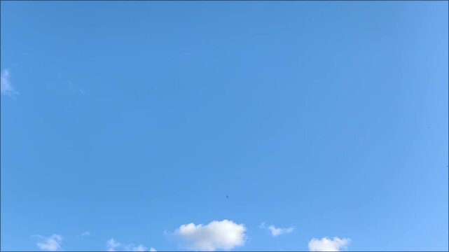 Bright blue sky with a few white clouds