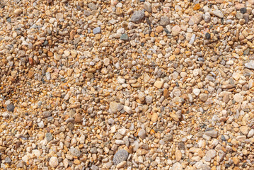 Close-up of small colorful beach pebbles and stones forming a natural texture