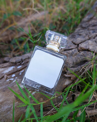 Perfume bottle mockup with plain white label on the wood nature background