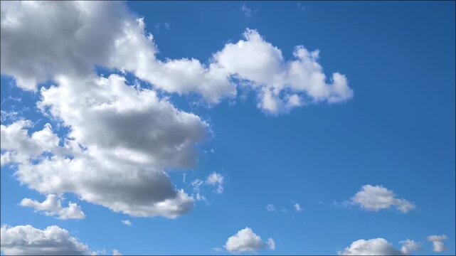 Bright blue sky with clouds moving away