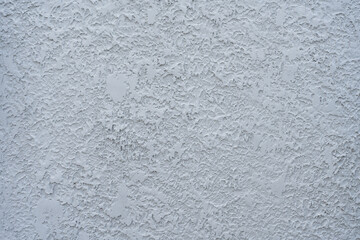 Fototapeta premium White cement wall panel with a rough pattern. The design consists of irregular