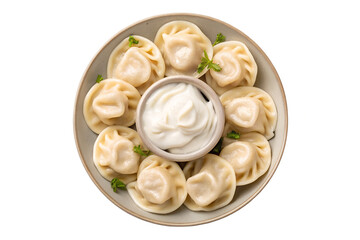 A top down view of a plate of dumplings with a small bowl of sour cream in the center