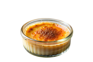 Close up of cr&egrave;me br&ucirc;l&eacute;e in a clear glass ramekin with a caramelized sugar crust on top