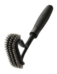 Grill cleaning brush with a flexible head on a backyard kettle grill.