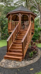 Obraz premium Wooden gazebo with curved staircase in a lush garden