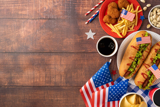 Labor Day and Independence Day picnic party concept featuring delicious American cuisine, including hot dogs, fries - Powered by Adobe