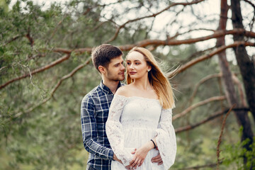 Fototapeta premium Beautiful couple spend time in a summer park