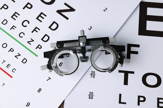 Vision test charts and trial frame on table, top view