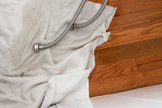 washing machine fill hose leaking on the floor - Powered by Adobe