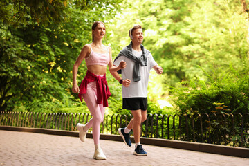 Happy couple running in park. Morning exercise
