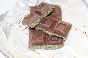 Chocolate with pistachio isolated on white background. Close-up.