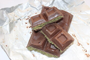 Chocolate with pistachio isolated on white background. Close-up.