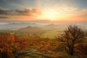 Wonderful beautiful amazing autumn fall sunrise in landscape of Czech Central Mountains, colorful clouds, fields and trees, serenity and peace