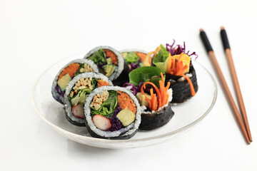 Gimbap, Rice Roll made with Various Ingredients, Eggs, Carrots, Purple Cabbage, Eomuk, and Lettuce