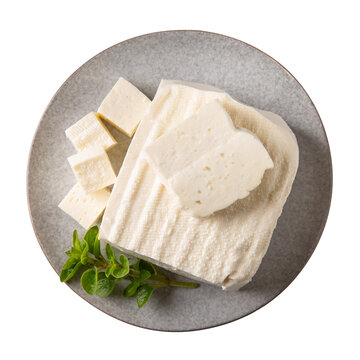 Brynza cheese isolated on white background. Soft sheep's cheese bryndza on gray plate. Top view.