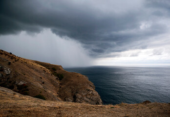 Thunderclouds and torrential rain on the southern coast of Crimea in the Balaklava area. Sevastopol, Crimea