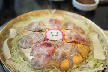 Sliced piece of pork meat was grilling on BBQ pan. Food cooking with object photo, close-up and selectice focus.
