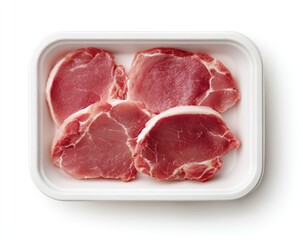 Four raw pork chops, pale pink, arranged in a rectangular white plastic tray, isolated on a white background