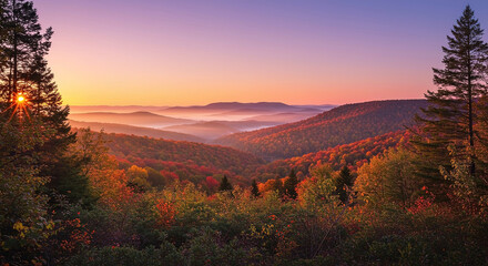 Stunning autumn sunrise over misty valleys in the mountains with vibrant colors and serene nature