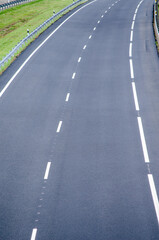 A long and empty highway curving through a beautiful rural landscape journey and travel concept