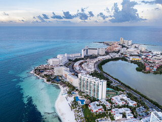 Drone aerial landscape view of hot area in cancun with white building and beach houses by the...