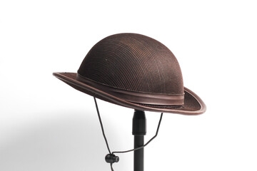Scout hat hanging on a mini tripod isolated on a white background